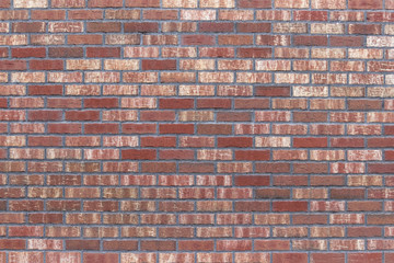 Wall of red-brown brick. Textural background. The facade of the old beautiful building