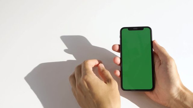 Man Using Phone with Green Screen on the white background