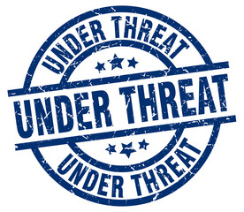 under threat blue round grunge stamp