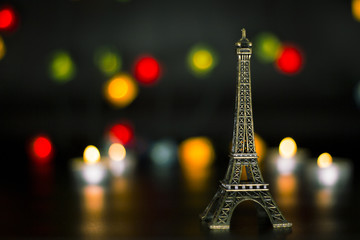 Eiffel tower on the background of colorful lights garland, bokeh.