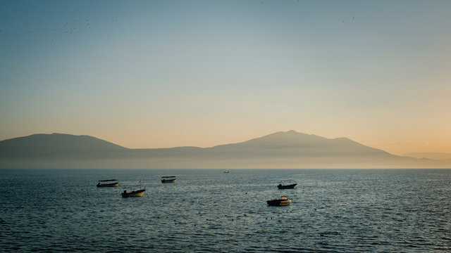 Sea, lake, boat, sun, mountain, dream, travel, sky, blue, water.
