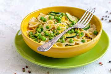 Traditional pasta with green peas and zucchini.