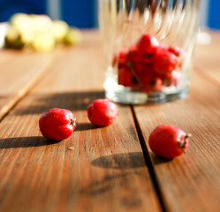 red berries on the wood table on summer time
