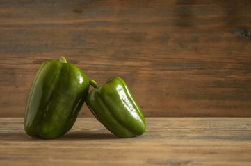 fresh green pepper on wooden background.