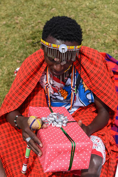 Maasai man holding a gift box