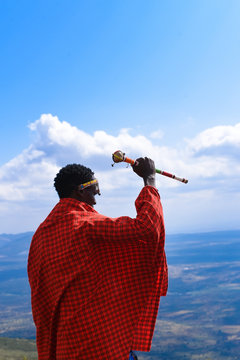 Maasai man holding beaded stick