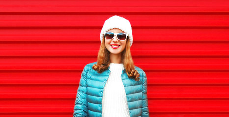 Fashion portrait pretty smiling woman on a red background close-up