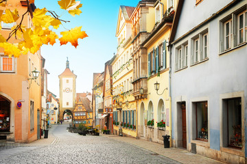 Fototapeta na wymiar old street, Plonlein and city tower of Rothenburg ob der Tauber at fall, Germany, retro toned