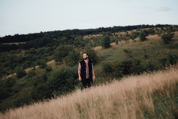 a man hipster walks in an autumn park