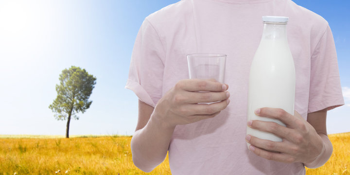 young man with bottle of milk and glass, fresh milk
