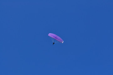 paraglider against blue sky