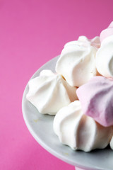 Fototapeta na wymiar Meringue. Crispy white and pink twisted meringue. Concept love of sweet