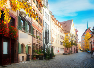 Fototapeta na wymiar Historic street in old town of Nuremberg, Germany at fall, retro toned