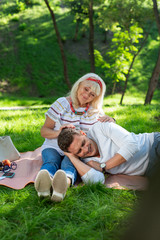 Fototapeta premium So happy with you. Cheerful female person bowing her head while looking at her kid