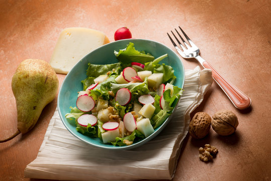 salad with cheese pear radish lettuce and nuts
