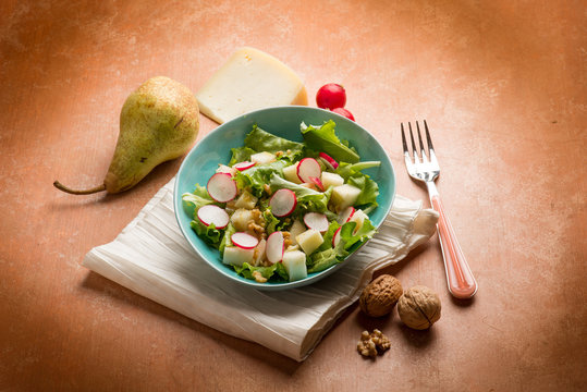 salad with cheese pear radish lettuce and nuts
