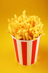 Potatoes French Fries in Red and white Carton Package Box. Fast Food.