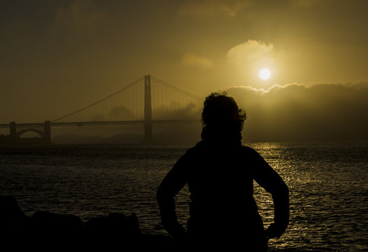 Woman looking at the Golden Gate Bridge in San Francisco, California, summer 2018