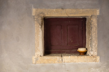 Brown and beige bowl on a closed window