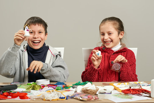 Childrens making decorations for new year holiday. Painting watercolors. Top view. Artwork workplace with creative accessories.