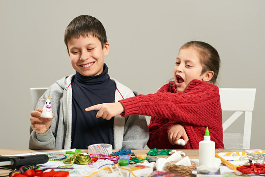 Childrens making decorations for new year holiday. Painting watercolors. Top view. Artwork workplace with creative accessories.