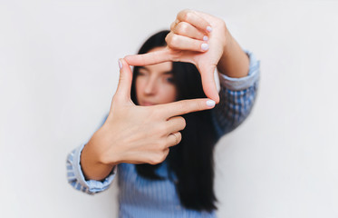 Female hands are planning a focus in the frame. Focal crop composition in the shot. A beautiful...