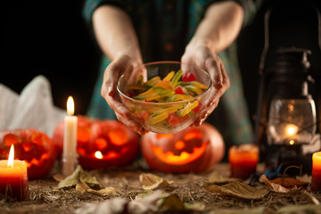 Obraz na płótnie Canvas preparation for halloween, sweets on a pumpkin background