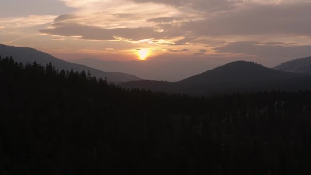 Up and in tracking shot of the sunset over Pattee Canyon near Missoula, Montana.