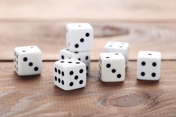 White dice on brown wooden table