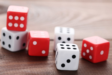 Colourful dice on brown wooden table