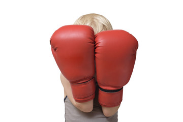 Blond boy is protected in two boxing gloves. Portrait.  Isolate