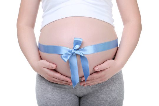 Pregnant woman with blue ribbon on white background