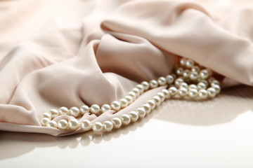 Pearl necklace with beige satin fabric