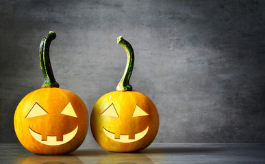 Scary Halloween pumpkins isolated on a black background. Scary smiling faces trick or treat.