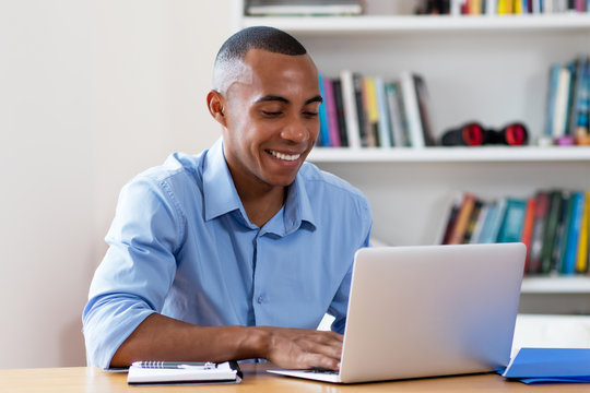 Smart african american businessman with computer