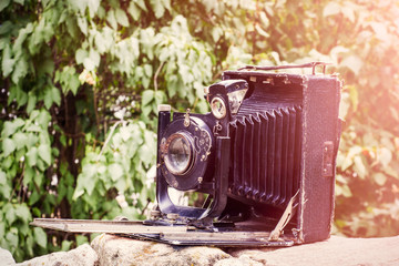 Folding photo cameras fold into a compact and rugged package for storage.