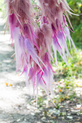 Fototapeta premium Handmade dream catcher with feathers threads and beads rope hanging