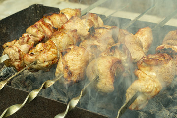 fried pork meat, shish kebabs, cooked on charcoal grill in the open air