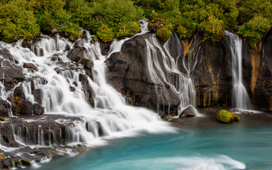 Hraunfossar Barnafoss waterfall Iceland, a series of waterfalls formed by rivulets streaming over a...
