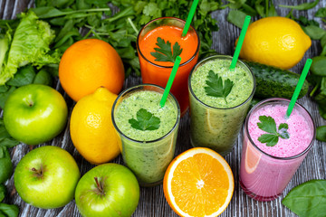 multicolor smoothies and fruits on wooden background