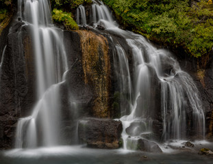 Hraunfossar Barnafoss waterfall Iceland, a series of waterfalls formed by rivulets streaming over a...