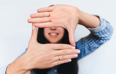 Female hands are planning a focus in the frame. Focal crop composition in the shot. Photo school. A...