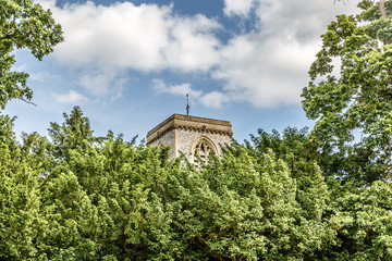 Fototapeta na wymiar Tower surrounded by trees in Blickling, north of Aylsham, a summer day