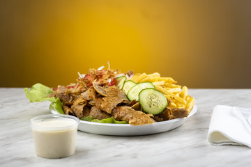 meat with kebab, French fries and salad