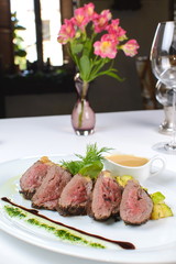 fillet mignon with sauce on a white plate