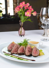 fillet mignon with sauce on a white plate