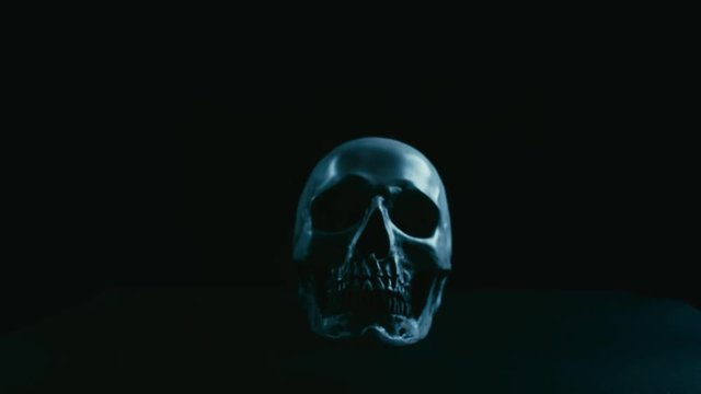 Skull in darkness with smoke, stabilizer camera movement