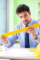 Young male architect working at the project