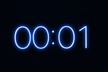 Digital clock timer stopwatch display showing 1 one second remaining in glowing blue numbers....