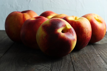 Group of ripe nectarines on dark wooden surface